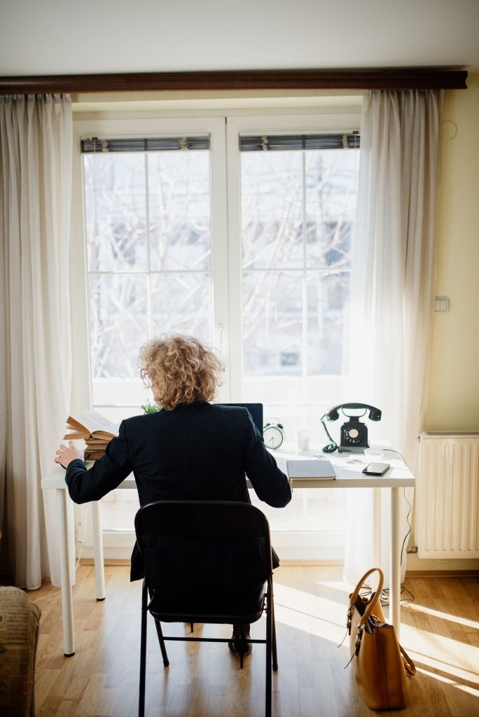 person working at desk with phone aside